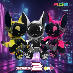 May include: Three plush toys in yellow, black, white, and pink. Each has a stylized animal face with large ears and a headset. The toys are labelled "RGB Protogens" and "Series 2 YWP".