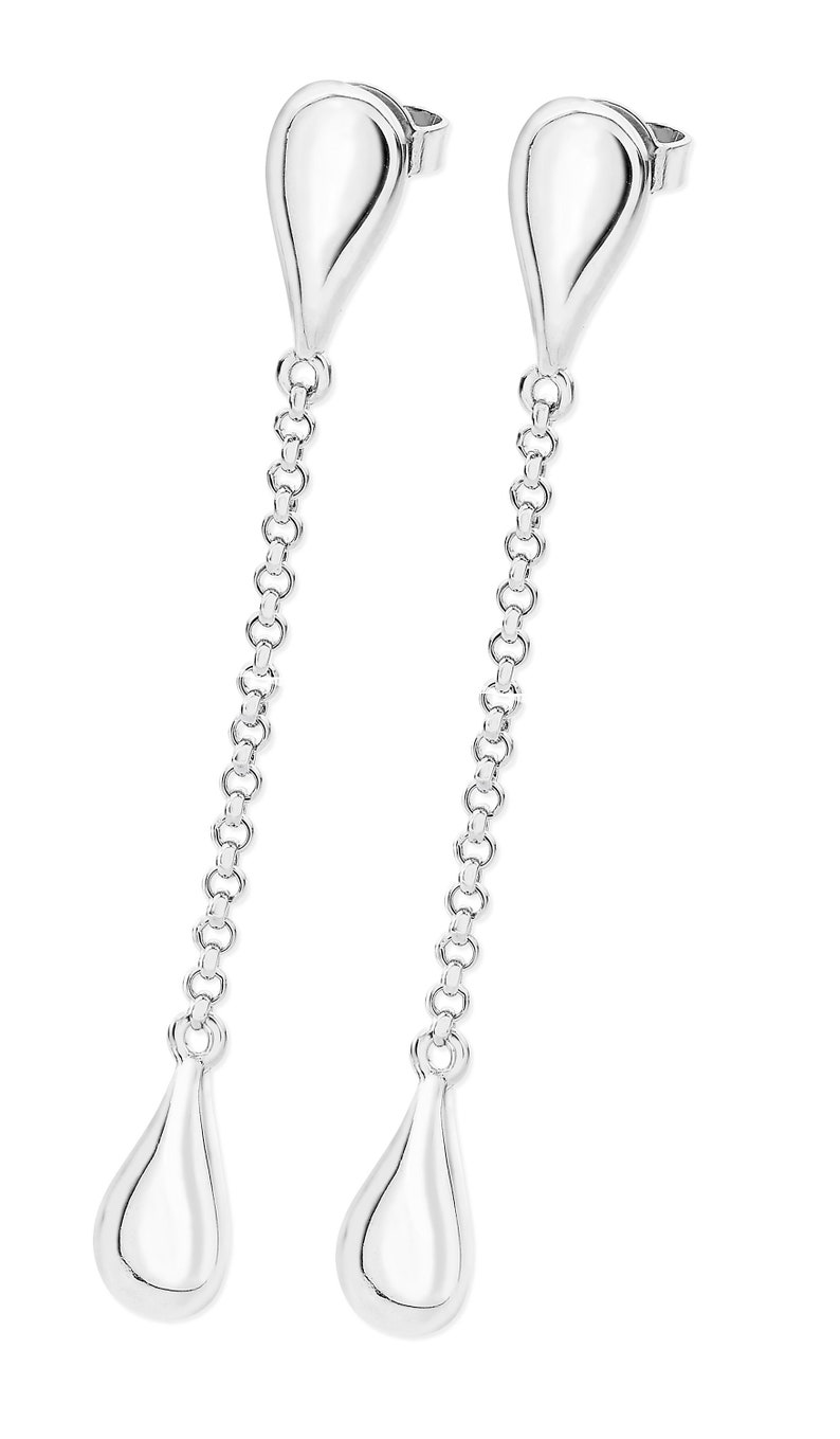 May include: A pair of silver teardrop earrings with a delicate chain connecting the two teardrop shapes.