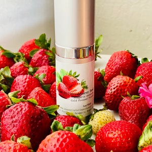 May include: A silver and white essential oil bottle labeled "Strawberry Seed" with a strawberry illustration, surrounded by fresh, ripe strawberries. The bottle is 1oz/30ml and the strawberries are a vibrant red.