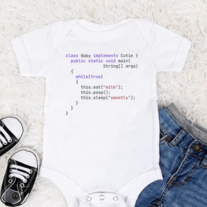 May include: White baby onesie with a purple code snippet that reads "class Baby implements Cutie { public static void main(String[] args) { while(true) { this.eat("milk"); this.poop(); this.sleep("sweetly"); } } }". The onesie is lying on a white fuzzy surface with a pair of black baby shoes and blue jeans.
