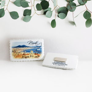 May include: White ceramic magnet with a picture of Naples, Italy. The back of the magnet has the text "IL FRANCOBOLLO ceramicastema.com handmade".
