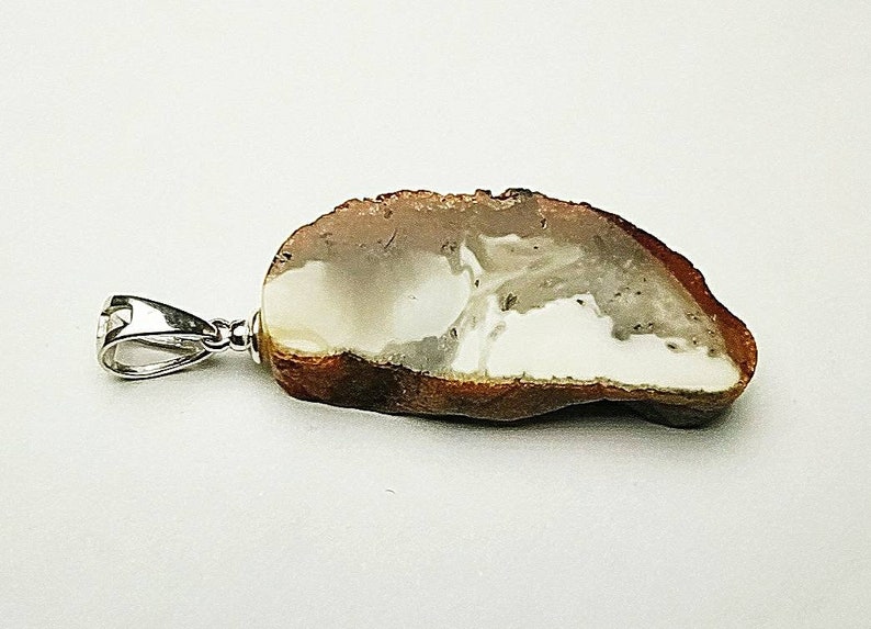 Pendant made of natural amber A piece of bread with a crust.