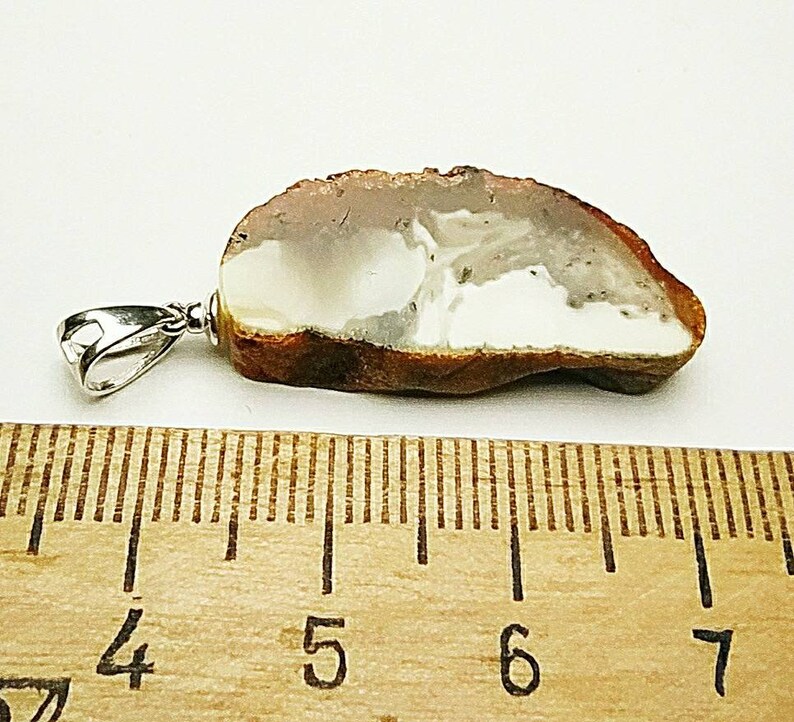 Pendant made of natural amber A piece of bread with a crust.