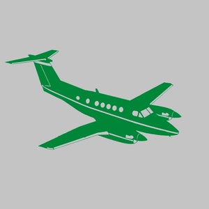 Könnte beinhalten: Eine grüne Silhouette eines kleinen Privatflugzeugs mit einem einzelnen Propeller am Heck.