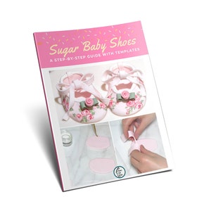 May include: A pink book titled "Sugar Baby Shoes" with a step-by-step guide. The cover features two baby shoes decorated with pink roses, green bows, and white ribbons. Additional images show the shoe-making process.