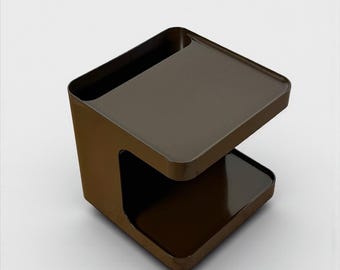 May include: A modern, brown side table with a unique, open-sided design. The table features two rectangular surfaces, one at the top and one below, connected by a curved support. The table is made of a glossy material and has a minimalist aesthetic.