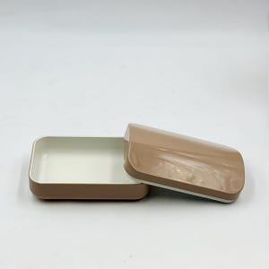 May include: A set of three ceramic mugs with a speckled, matte finish. The mugs are in shades of blue, green, and white. Each mug has a rounded shape and a simple, modern design. The mugs are likely for coffee or tea.