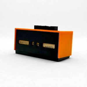 Calendario perpetuo de los años 70, naranja y negro, de escritorio, en idioma italiano.