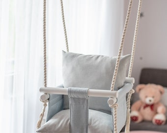 A swing for children with OhSwing Baby Gray backrest.