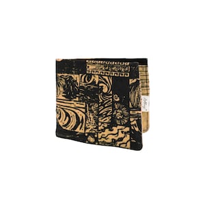 May include: A black and tan patterned wallet with a small label that says "Little Wing".