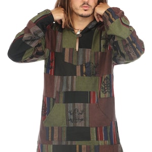 May include: A long-sleeved patchwork shirt with a hood. The shirt is made of a variety of fabrics in shades of green, brown, black, and red. The shirt features a small pocket on the front and a zipper closure at the neck.