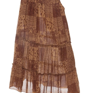 May include: A brown maxi skirt with a patchwork design and multiple tiers. The skirt has a drawstring waist and a relaxed fit.