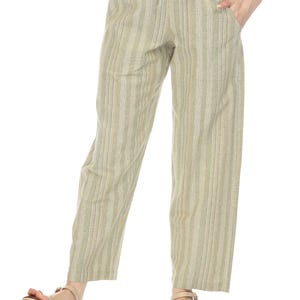 May include: Green striped pants with a drawstring waist. The pants are made of a lightweight fabric and have a relaxed fit.