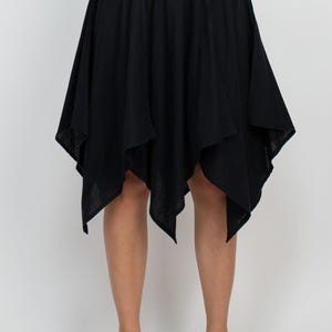 May include: A black asymmetrical skirt with a gathered elastic waistband.