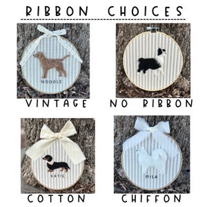 May include: Four embroidered dog portraits in wooden hoops with striped fabric backgrounds. Each hoop features a different ribbon choice: vintage lace, no ribbon, cotton bow, and chiffon bow. The dogs are named Noodle, Katie, and Mila.