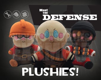 May include: Three plush dolls of characters from "Meet the Defense" are displayed. The dolls have large heads, round faces, and are wearing outfits and hats. The text "Meet the Defense Plushies!" is at the top and bottom of the image.