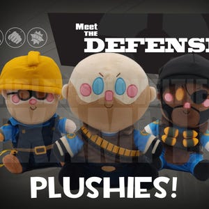 May include: Three plush dolls of characters from a video game, each with unique outfits and facial features. The dolls are in blue, yellow, and brown, with the text "Meet the Defense Plushies!" across the image.