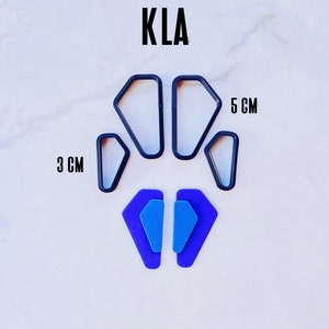 May include: Set of five black plastic cookie cutters in the shape of a diamond. The cutters are arranged in a circle with the largest cutter in the center. The cutters are 3 cm and 5 cm in size. Two blue diamond-shaped polymer clay earrings are shown below the cutters.