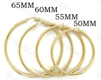 May include: Four gold hoop earrings in different sizes: 65mm, 60mm, 55mm, and 50mm. The earrings are all made of a thick, round wire.