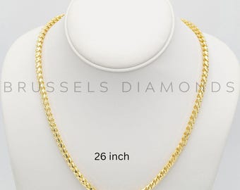 May include: A gold chain necklace on a white display stand. The chain is 26 inches long and has a curb link design.