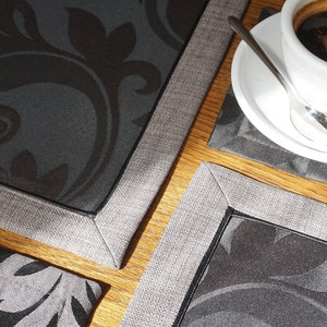 Elegant minimalistic black placemats and coasters set with floral pattern