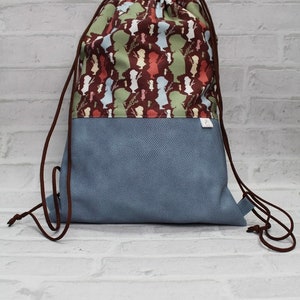 Gym bag or backpack made of light blue imitation leather with brown cotton with flower girl