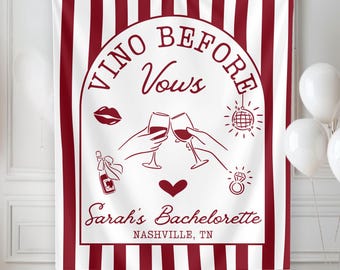 May include: A rectangular wall tapestry featuring vertical maroon and white stripes. The center displays a white arch containing the text "VINO BEFORE Vows", "Sarah's Bachelorette", and "NASHVILLE, TN", alongside illustrations of wine glasses, a disco ball, a ring, and lips.