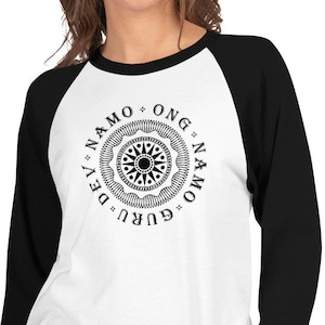 May include: A white and black baseball tee shirt with a black and white mandala design and the text "Guru * Namo * Ong * Namo * Dev" around the mandala.