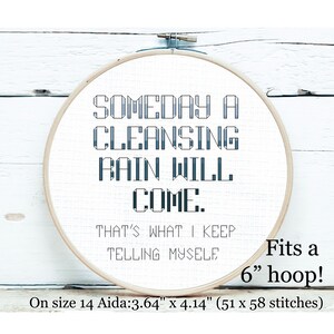 May include: A cross-stitch embroidery hoop with the text "SOMEDAY A CLEANSING RAIN WILL COME. THAT'S WHAT I KEEP TELLING MYSELF" in blue and white. The embroidery fits a 6-inch hoop and is on size 14 Aida cloth, measuring 3.64" x 4.14".