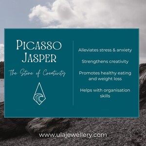 May include: A teal graphic with the words "Picasso Jasper" and "The Stone of Creativity." The graphic lists benefits including stress relief and creativity enhancement. The background shows a coastal scene with rocks and water.