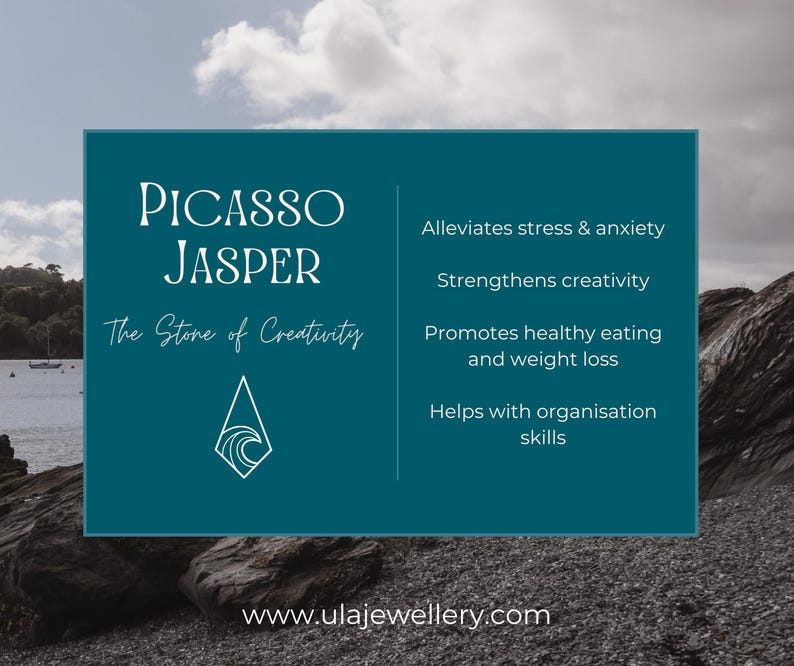 May include: A teal graphic with the words "Picasso Jasper" and "The Stone of Creativity." The graphic lists benefits including stress relief and creativity enhancement. The background shows a coastal scene with rocks and water.