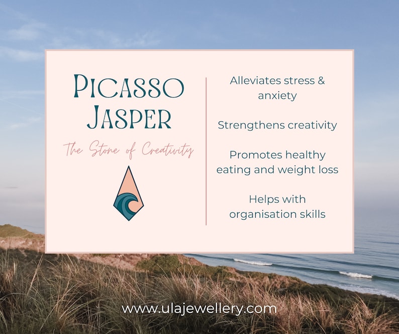 May include: A pink and white card with the text "Picasso Jasper" and "The Stone of Creativity". The card also features a blue and white wave design in a diamond shape. The card lists the benefits of Picasso Jasper, including alleviating stress and anxiety, strengthening creativity, promoting healthy eating and weight loss, and helping with organization skills. The card also includes the website address "www.ulajewellery.com".