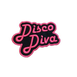 May include: Pink and black embroidered iron-on patch with the text "Disco Diva" in a cursive font.
