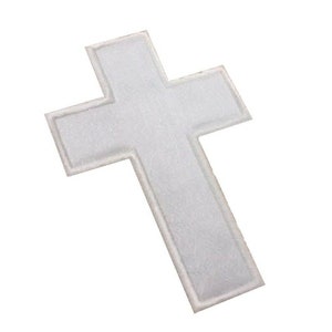 May include: White felt cross patch with a simple design.