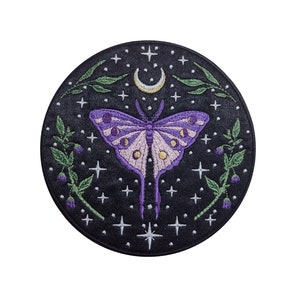 May include: A round embroidered patch featuring a purple and pink butterfly against a black background with white stars and a crescent moon.
