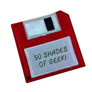 May include: Red floppy disk with a white label that says "50 SHADES OF GEEK!"