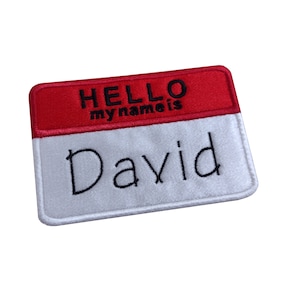 May include: White and red felt name tag with the text "HELLO my name is David" embroidered in black thread.
