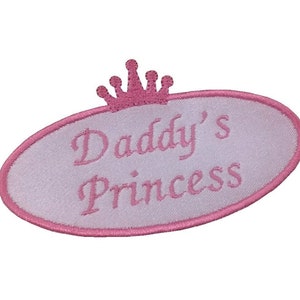 May include: Pink oval-shaped embroidered patch with a pink crown and the text "Daddy's Princess".
