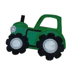 May include: Green tractor applique with black wheels and white tyre centres. The tractor has a black exhaust pipe.