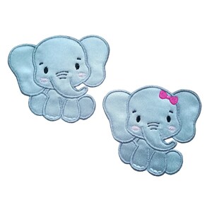 May include: Two embroidered iron-on patches of baby elephants. One elephant is light blue with pink cheeks and a pink bow. The other elephant is light blue with pink cheeks.