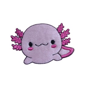 May include: Embroidered patch of a cartoon axolotl in pink and black. The axolotl has a smiling face, pink gills, and a tail. The patch is designed to be ironed or sewn onto fabric.