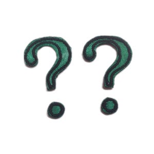 May include: Two green question mark patches with black edging on a white background. The patches have an embroidered texture. The question marks are a symbol of curiosity and mystery.