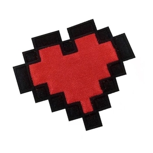 May include: A red pixelated heart shape with a black outline. The heart is made of fabric and is a patch.