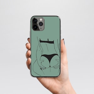 May include: A green phone case with a black line drawing of a person in underwear.