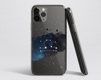May include: A clear phone case with a black background and a white Libra constellation design. The constellation is set against a blue and black watercolor-style galaxy background.