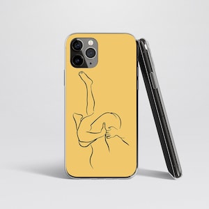 May include: A yellow phone case with a black line drawing of two people embracing.