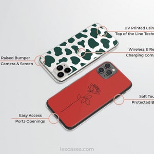 May include: Two phone cases, one with a green and white cow print design and the other with a red background and a black line drawing of a rose. Both cases have a raised bumper around the camera and screen, and both are compatible with wireless and reverse charging. The text "UV Printed using Top of the Line Technology" is visible on the top of the image.