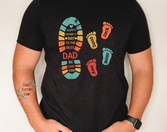 May include: A black t-shirt with a colorful footprint design that says "Happy Father's Day to the Best Dad We Love You".  The footprint design also includes the names "Jack", "Melissa", "Ava", and "David".