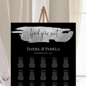 May include: Black wedding seating chart with silver glitter accents. The chart has the text "find your seat" and "Daniel & Pamela" with the date "December 11th, 2023". The chart is divided into 20 tables with names listed under each table.