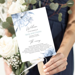 May include: A wedding program fan with a floral design in shades of blue. The program includes the names "Betty and Charles" and the date "December 17th, 2025". The ceremony details are also listed.